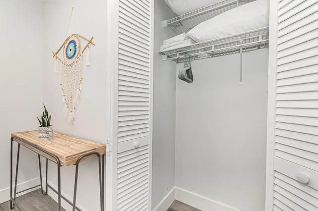 a bathroom with a granite countertop sink and shower
