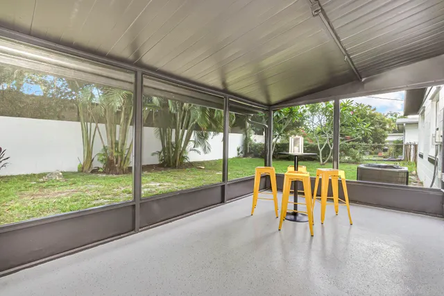 a view of a porch with furniture and garden