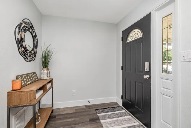 a view of an entryway with wooden floor