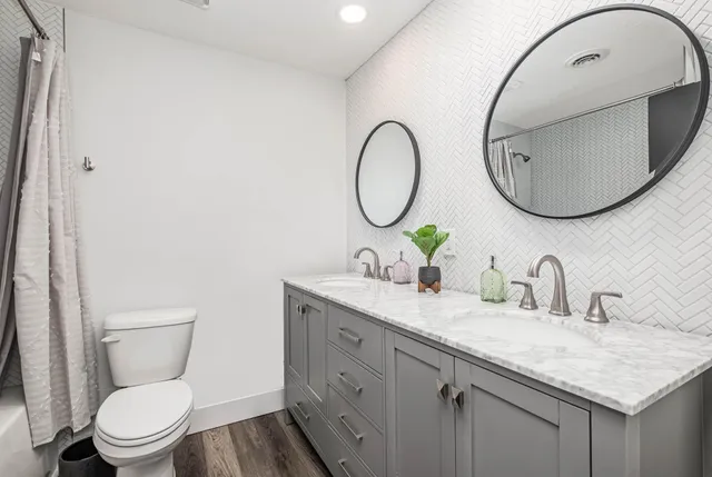 a bathroom with a toilet a sink and a mirror