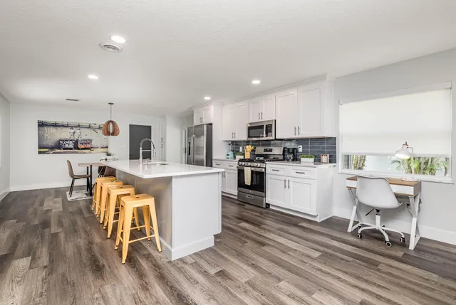 a kitchen with a sink a counter top space and appliances