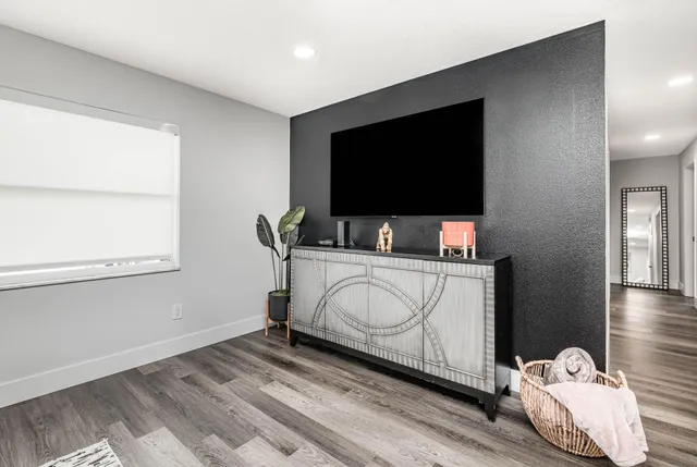 a bedroom with bed and flat screen tv