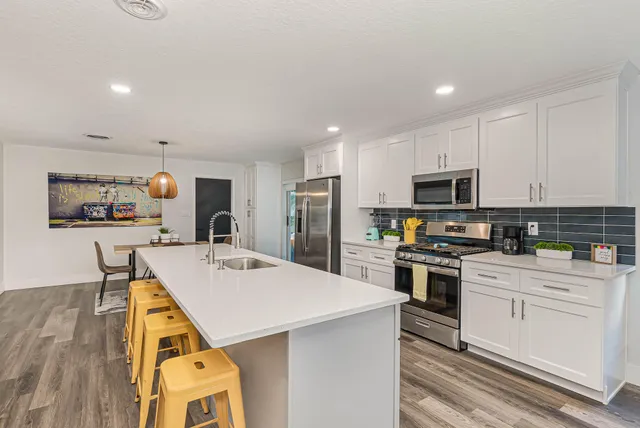 a kitchen with a sink a stove and refrigerator