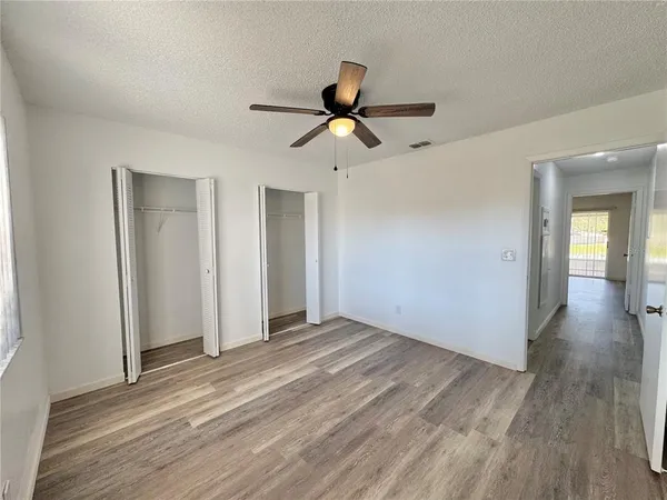 a view of empty room with wooden floor