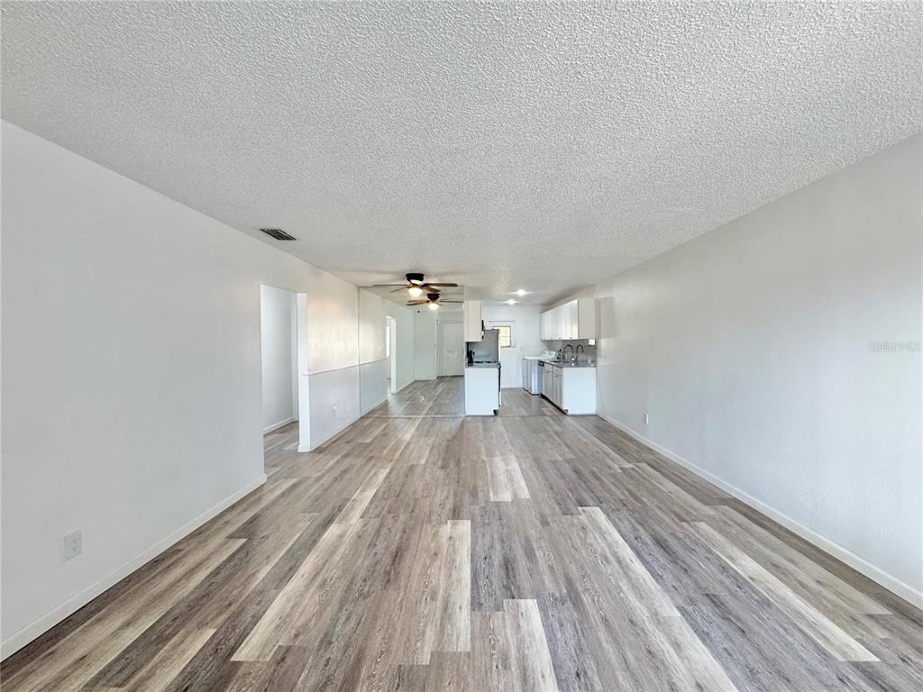 383 Winter Ridge Boulevard, Unit 383 Winter Haven, FL 33881 - Photo 4 of 35 a view of empty room with wooden floor