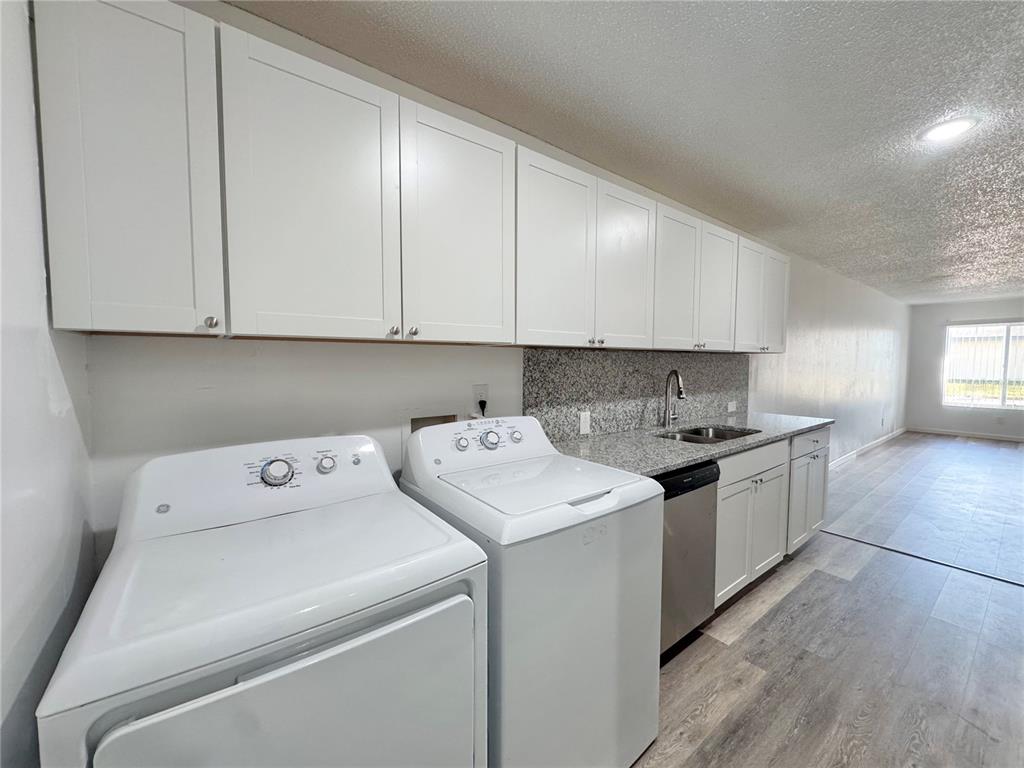 383 Winter Ridge Boulevard, Unit 383 Winter Haven, FL 33881 - Photo 9 of 35 a view of utility room with washer and dryer
