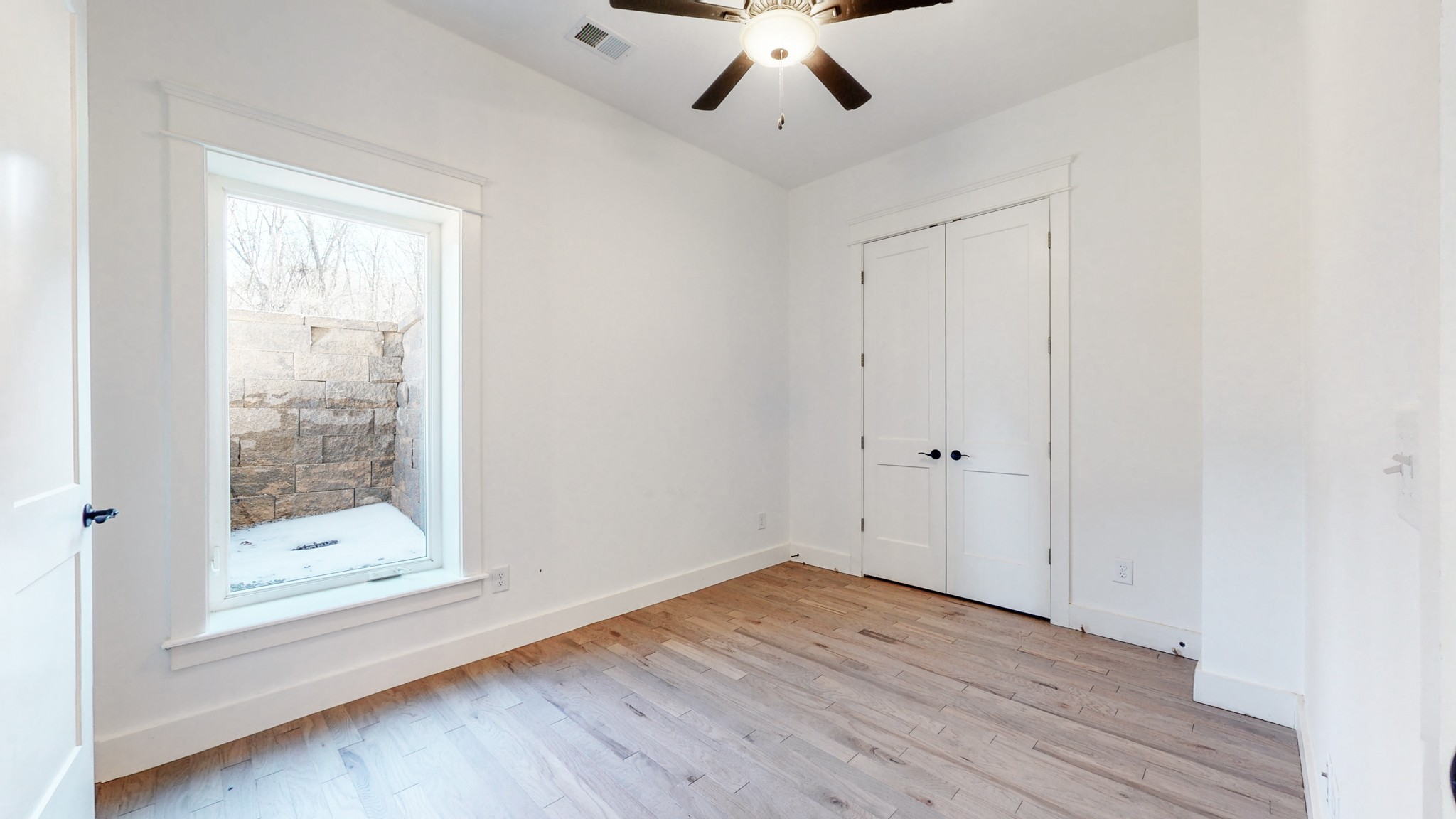 6720 Lane Road College Grove, TN 37046 - Photo 34 of 49 an empty room with wooden floor fan and windows