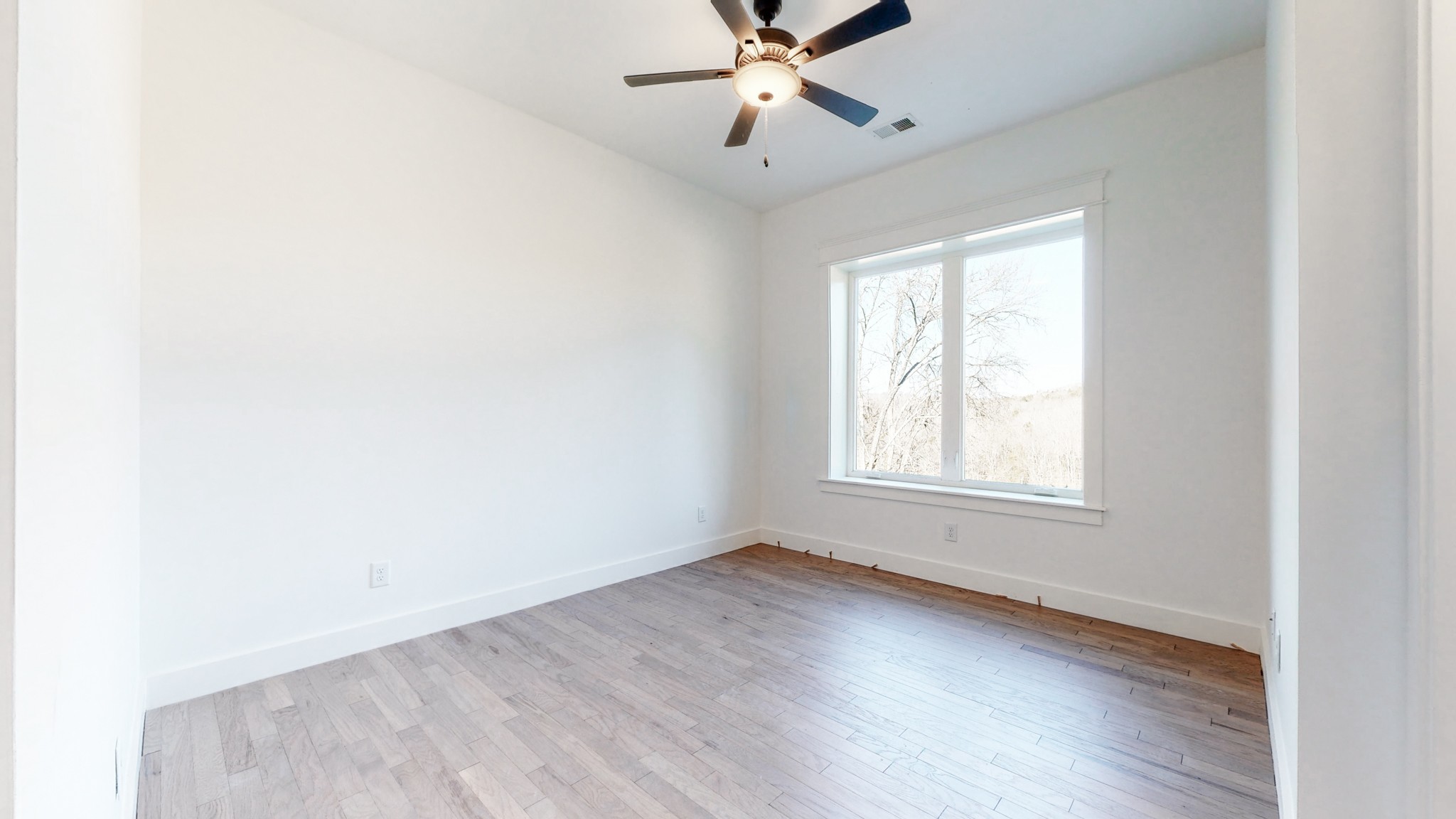 6720 Lane Road College Grove, TN 37046 - Photo 35 of 49 a view of an empty room with wooden floor and a window