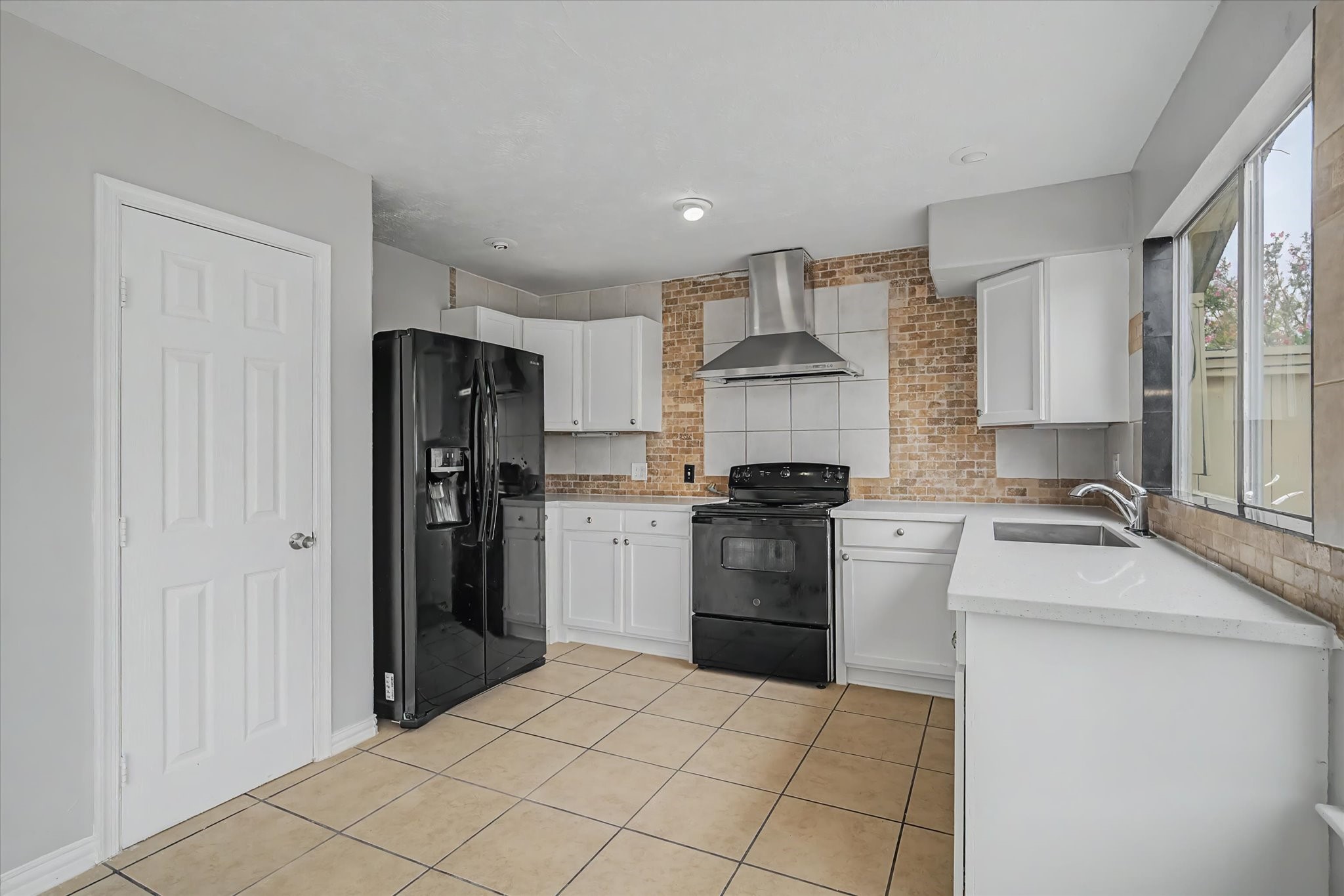 7330 South Dairy Ashford Road Houston, TX 77072 - Photo 13 of 33 a kitchen with a sink stove and refrigerator