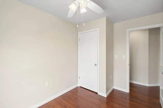a view of a porch with a door and wooden floor