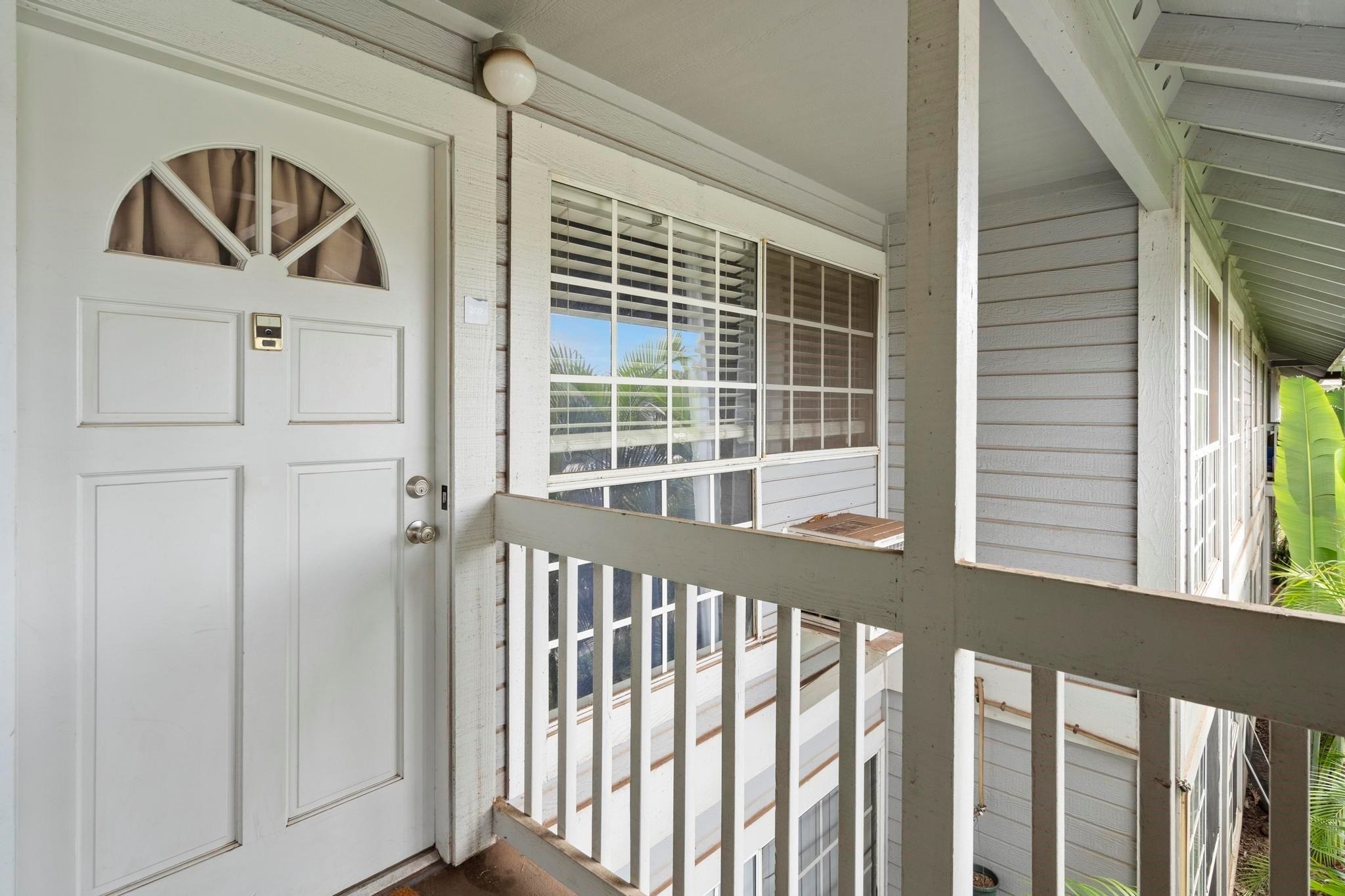 160 Keonekai Road, Unit 14202 Kihei, HI 96753 - Photo 15 of 21 a view of a porch with a door and wooden floor