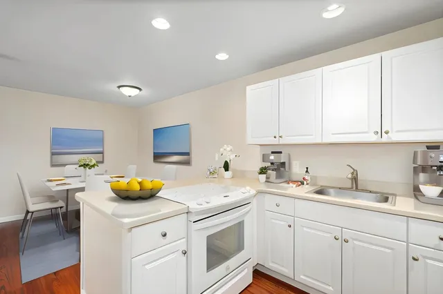 a kitchen with a sink a stove and cabinets