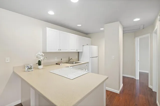 a utility room with a sink a cabinetry and appliances
