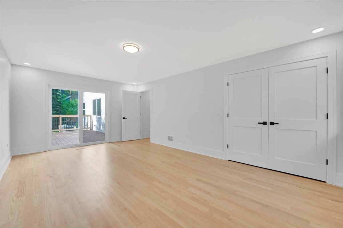 101 Devonshire Road, Unit 1 Tower Lakes, IL 60010 - Photo 15 of 38 a view of an empty room with wooden floor and a window