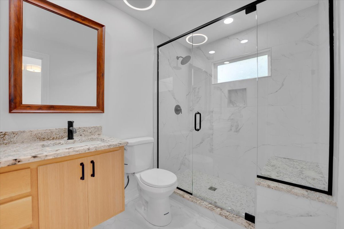 101 Devonshire Road, Unit 1 Tower Lakes, IL 60010 - Photo 20 of 38 a bathroom with a granite countertop sink toilet and shower