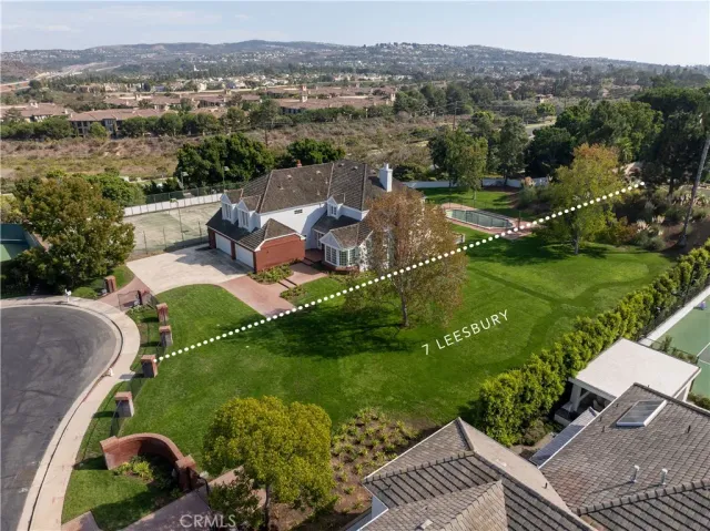 an aerial view of a house with a garden and lake view