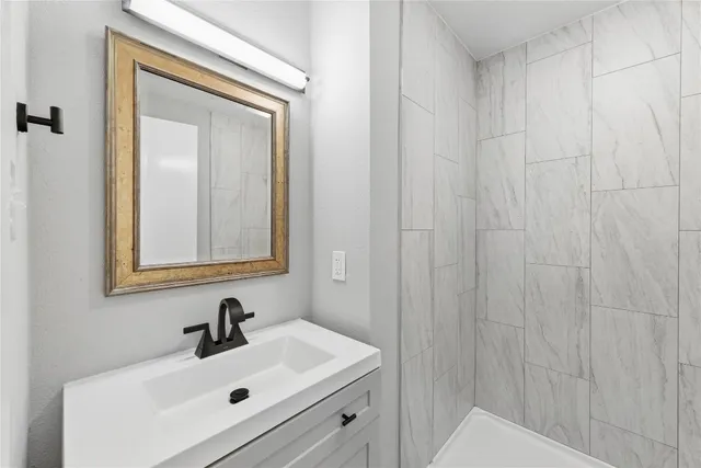 a bathroom with a sink a mirror and vanity