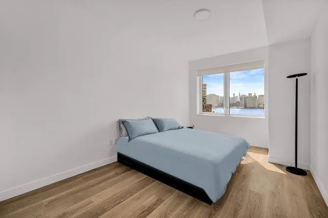 a bedroom with a bed and window