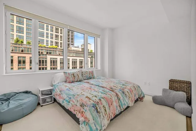 a bedroom with a bed and a couch with window