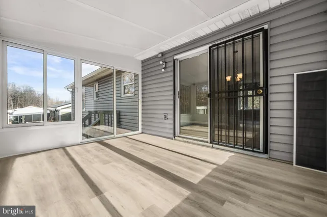a spacious bedroom with a large window and a balcony