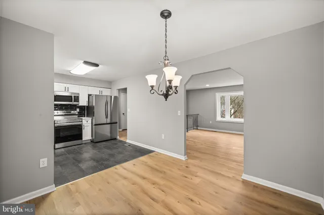a view of a kitchen with a sink wooden floor and a kitchen counter top space