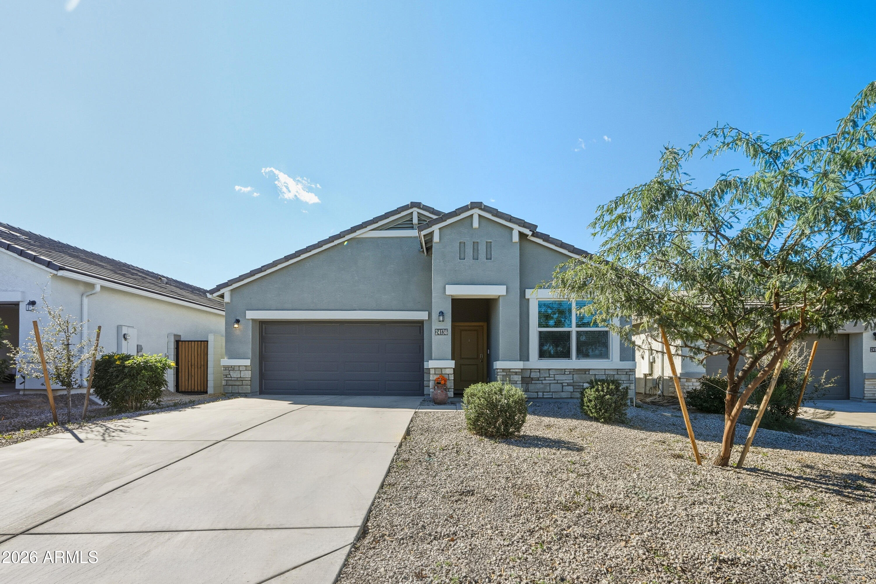 24136 Plow Road Florence, AZ 85132 - Photo 1 of 23 a front view of a house with garden