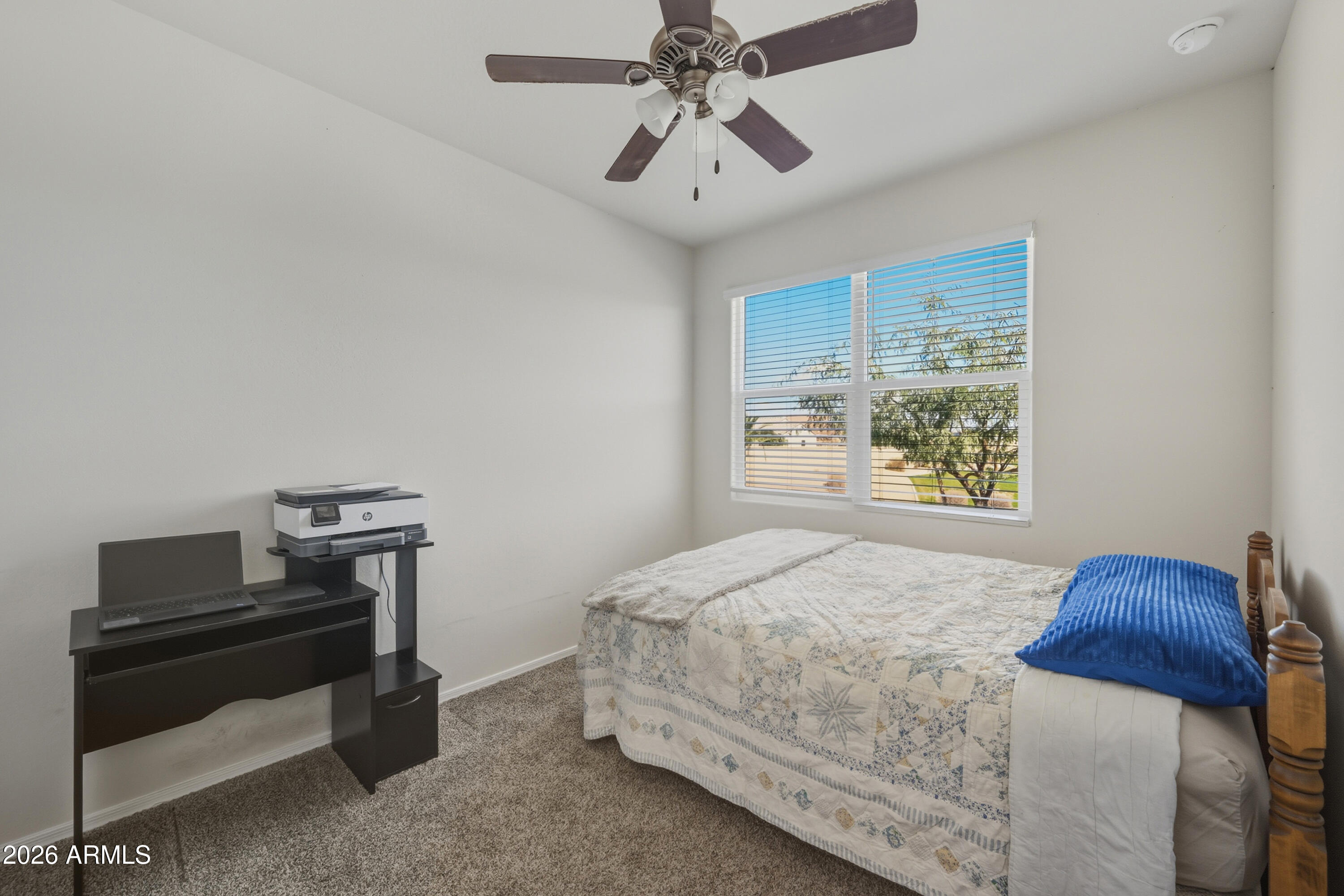 24136 Plow Road Florence, AZ 85132 - Photo 10 of 23 a bedroom with a bed and a chandelier