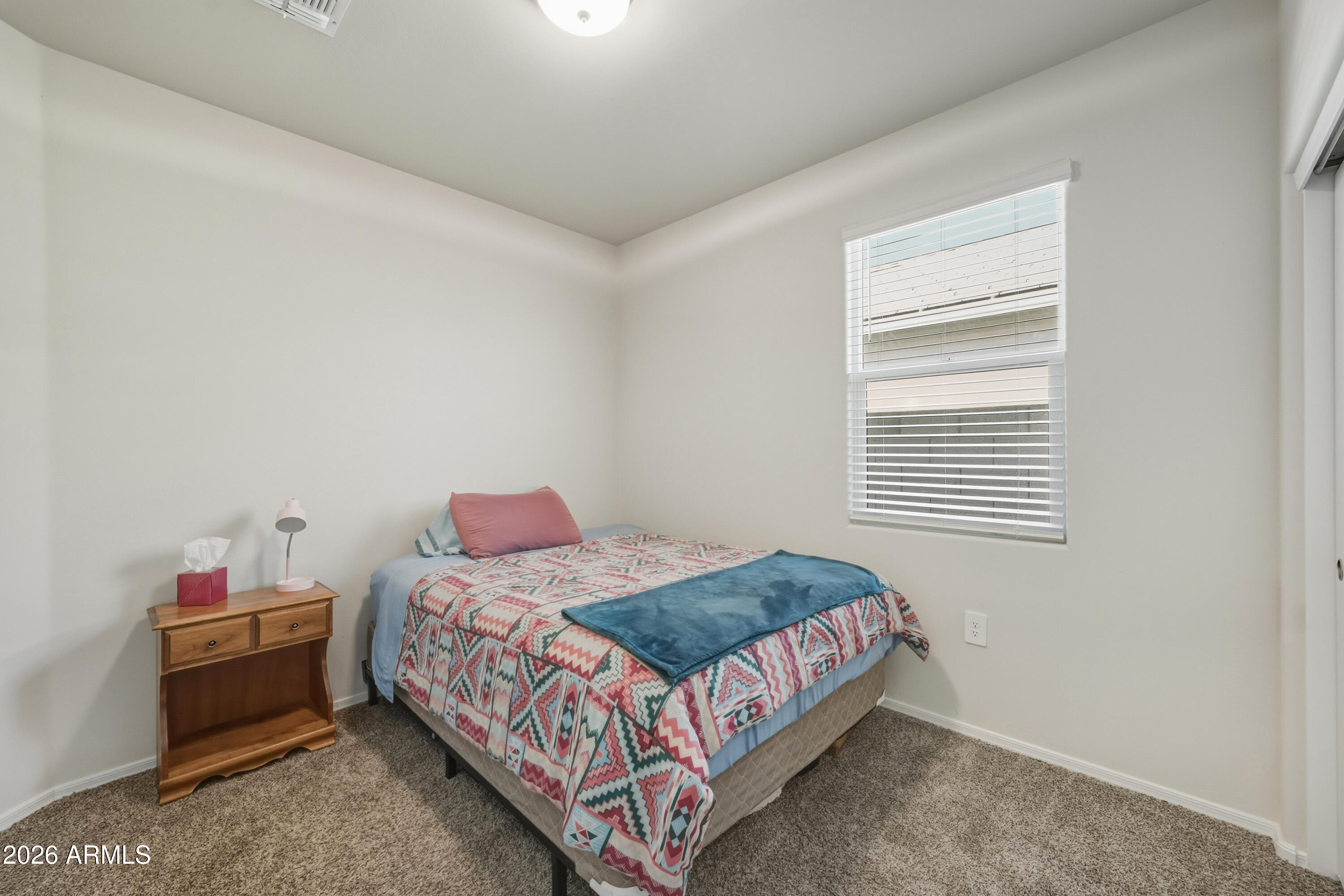 24136 Plow Road Florence, AZ 85132 - Photo 11 of 23 a bedroom with a bed and window