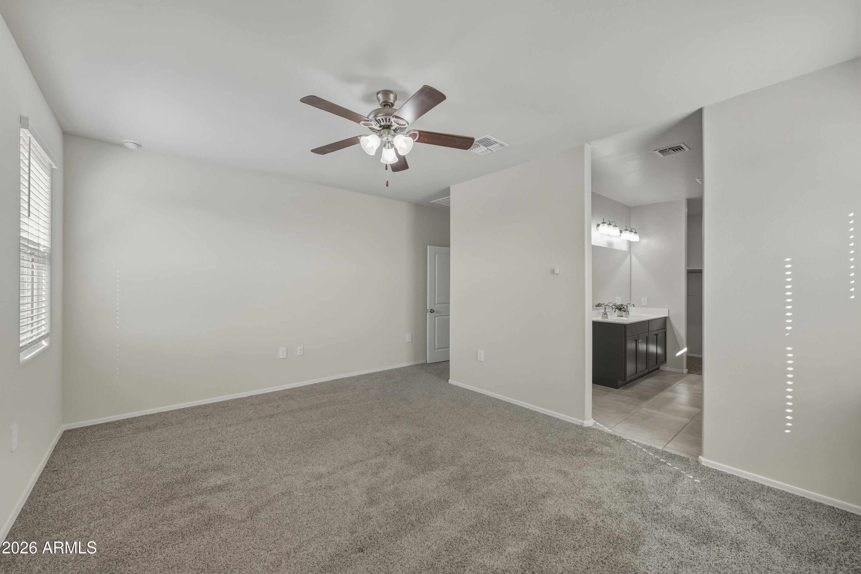 24136 Plow Road Florence, AZ 85132 - Photo 14 of 23 a view of an empty room and a ceiling fan