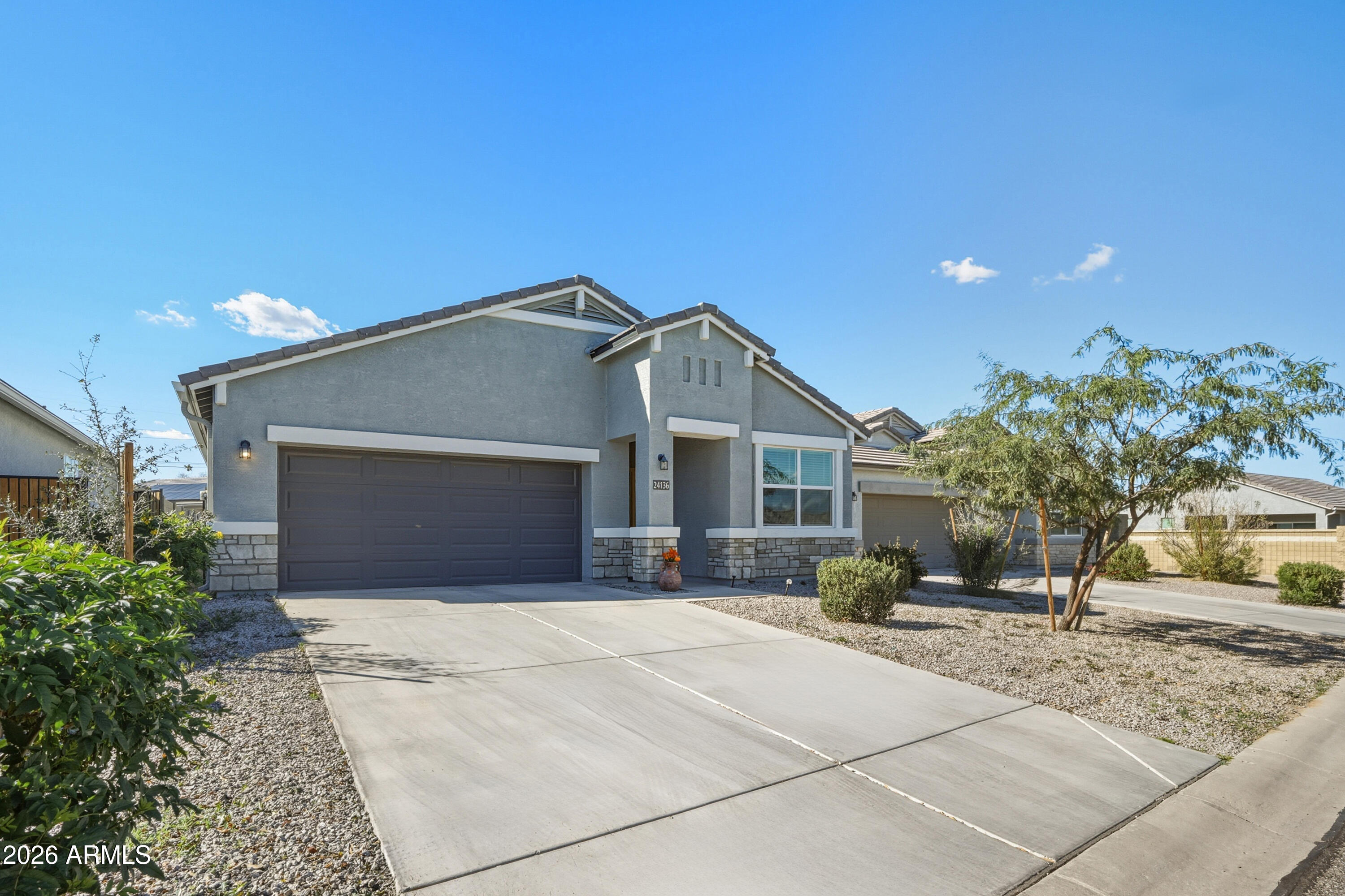 24136 Plow Road Florence, AZ 85132 - Photo 2 of 23 a front view of a house with a yard and garage