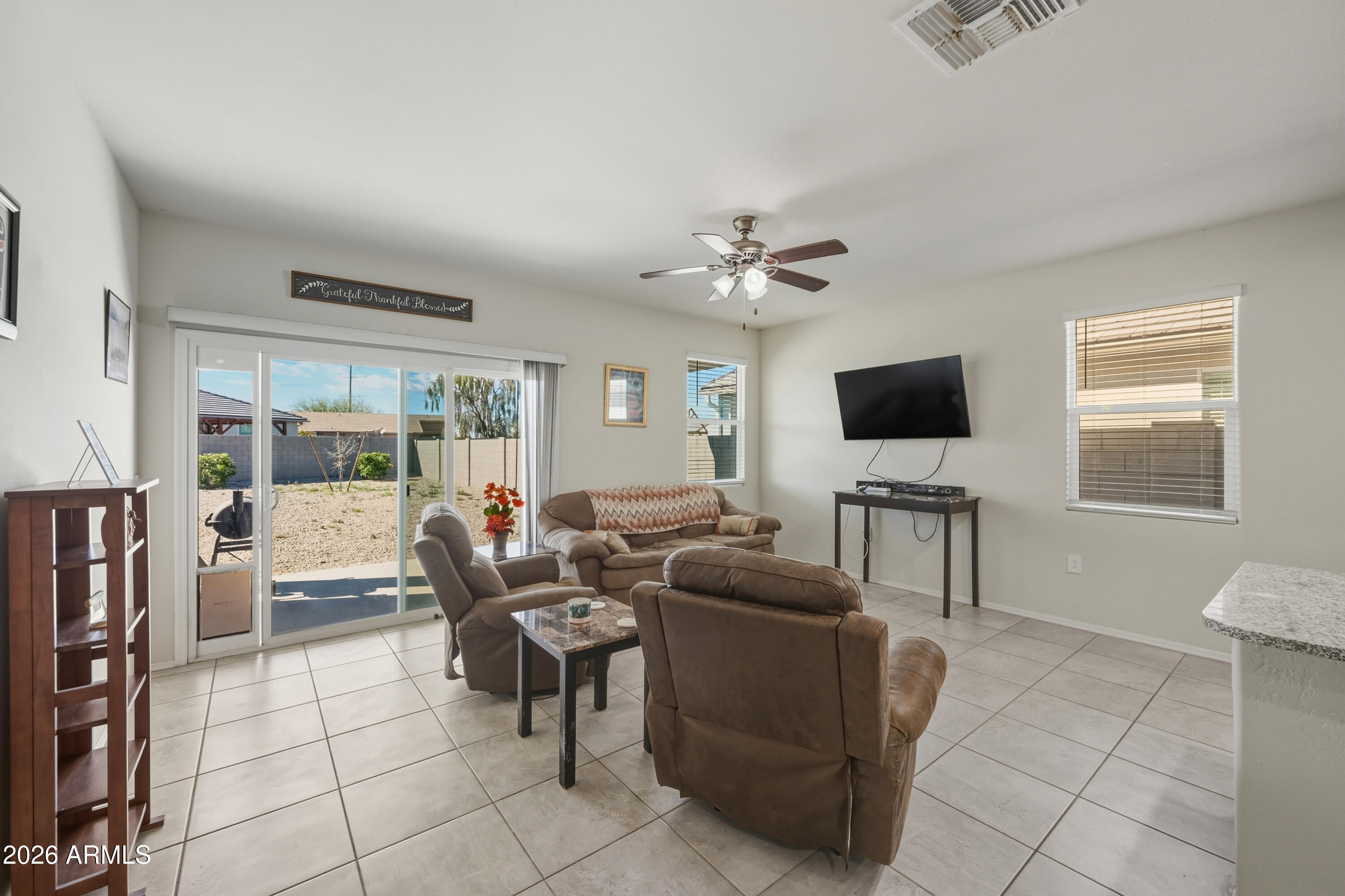 24136 Plow Road Florence, AZ 85132 - Photo 6 of 23 a living room with furniture and a flat screen tv