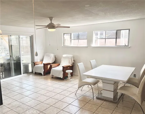 a living room with furniture a table and chairs