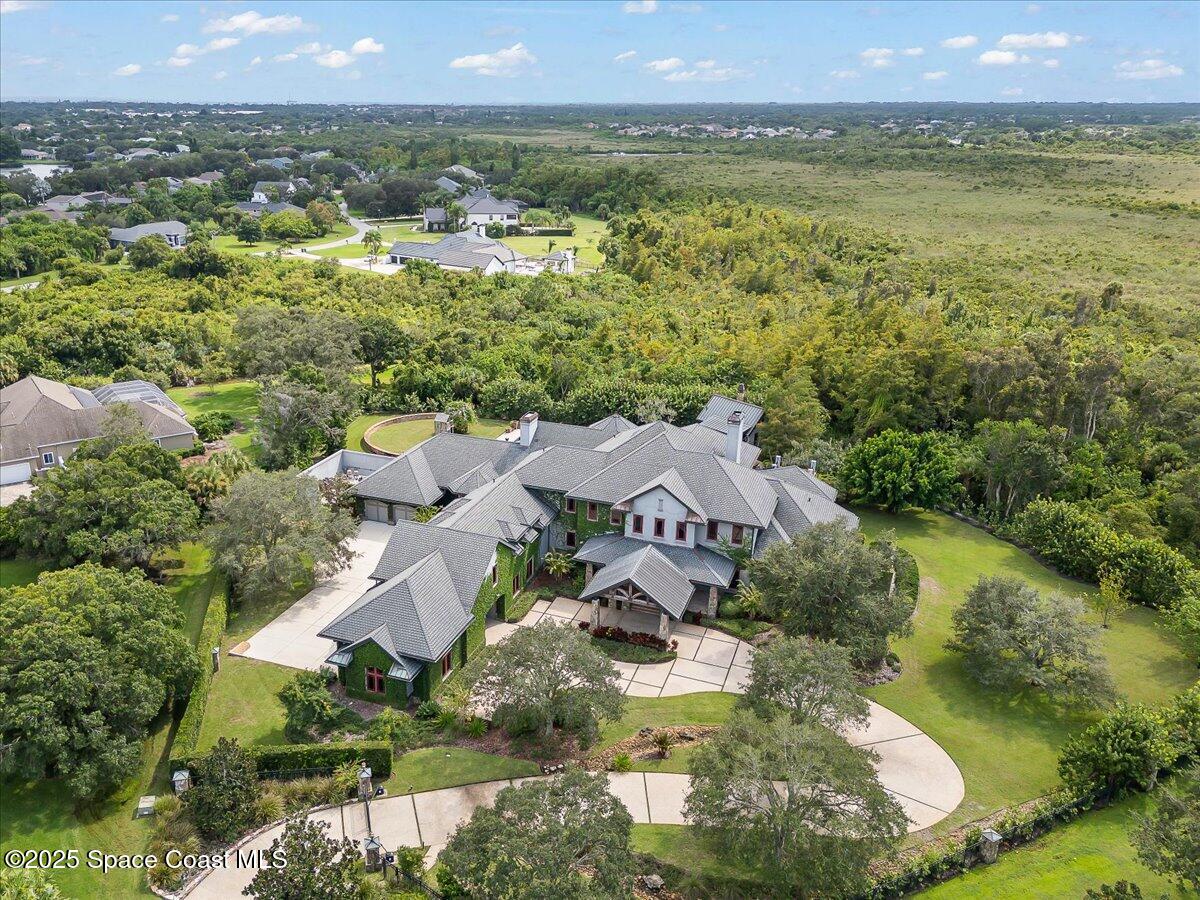 586 Wethersfield Place Melbourne, FL 32940 - Photo 102 of 112 an aerial view of residential houses with outdoor space and swimming pool