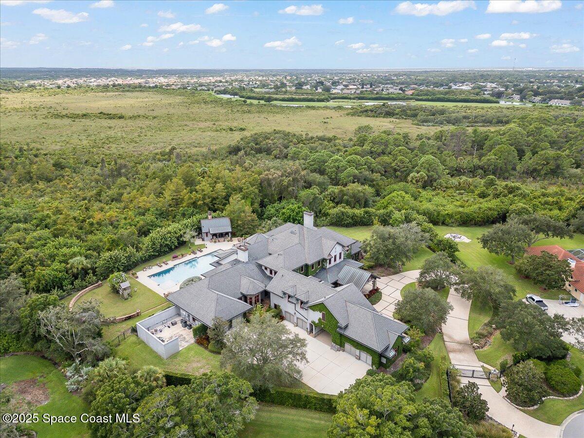 586 Wethersfield Place Melbourne, FL 32940 - Photo 105 of 112 an aerial view of residential building with outdoor space and lake view