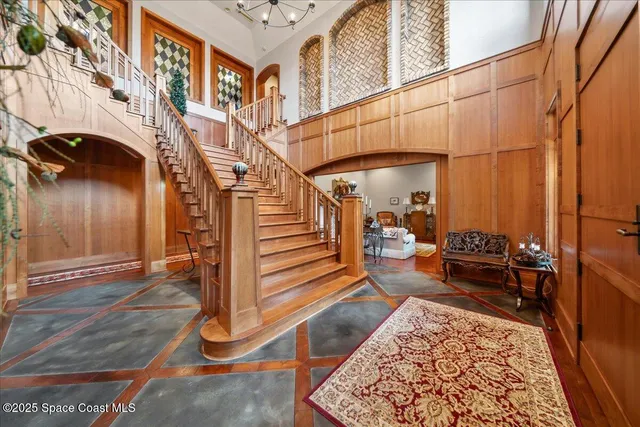 a living room with furniture a fireplace and a floor to ceiling window