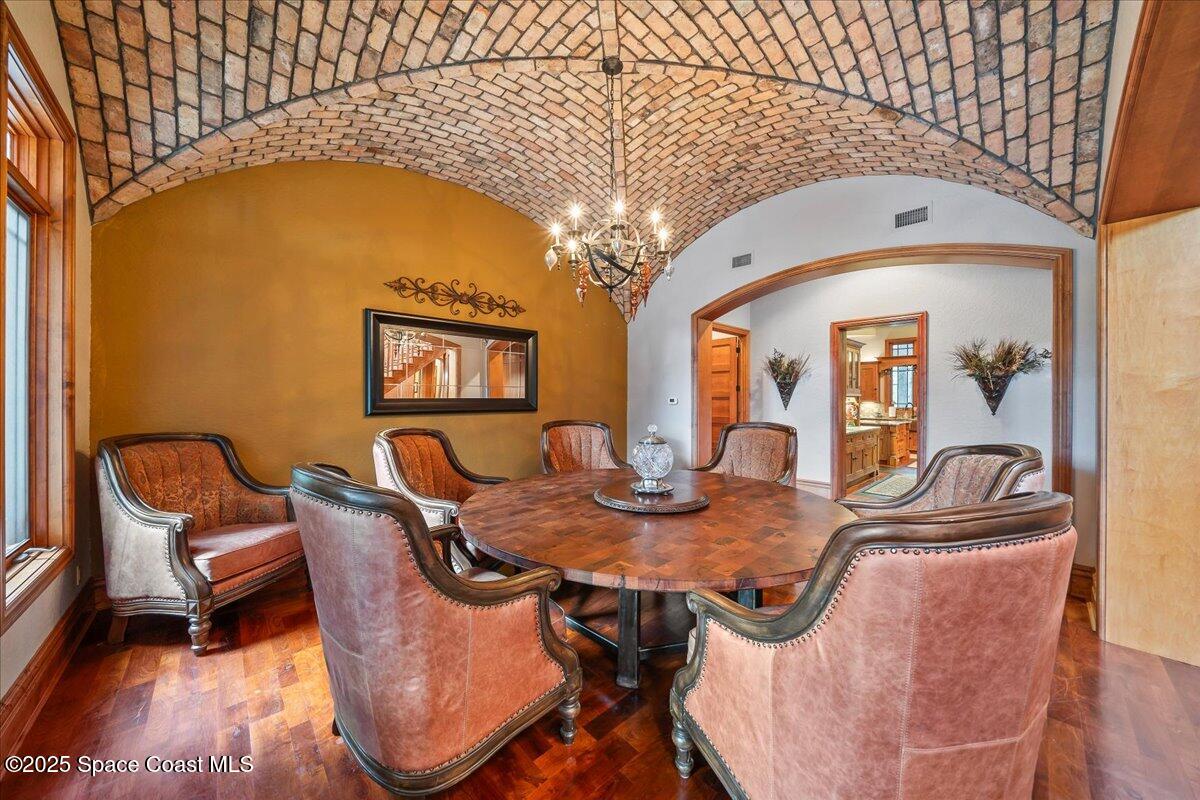 586 Wethersfield Place Melbourne, FL 32940 - Photo 22 of 112 a dining room with furniture and chandelier