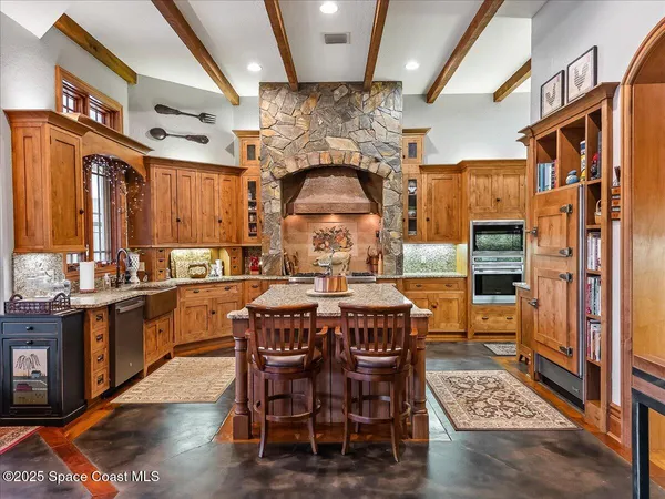 a spacious bedroom with a bed a couch and large window