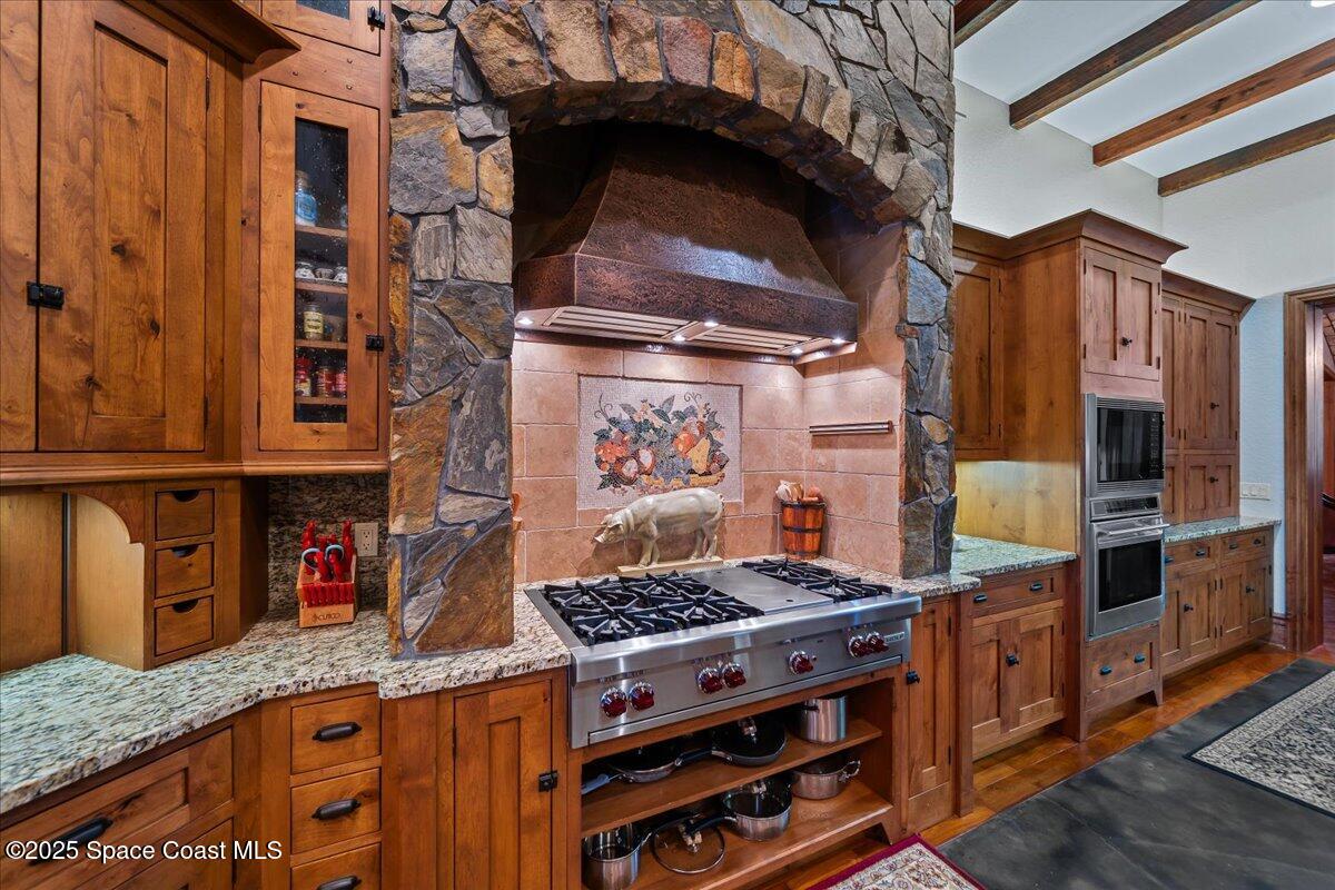 586 Wethersfield Place Melbourne, FL 32940 - Photo 24 of 112 a kitchen with stainless steel appliances granite countertop a stove and a cabinets