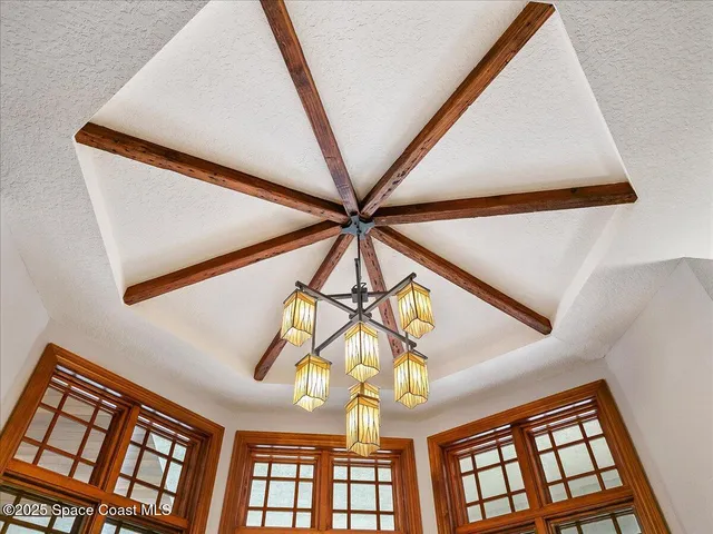a view of a hallway with wooden floor and entryway