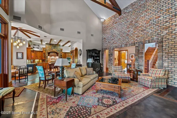 a bedroom with a bed a chandelier and a window