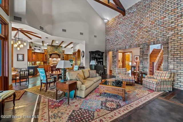 a bedroom with a bed a chandelier and a window