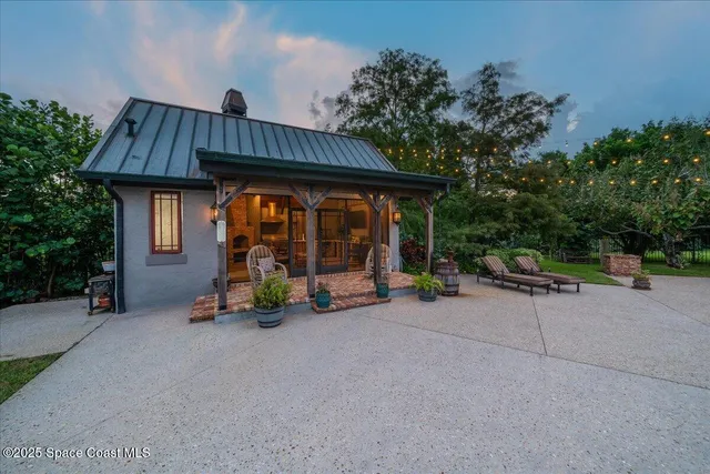 an aerial view of residential house with outdoor space and swimming pool
