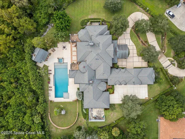 a front view of a house with a yard and potted plants