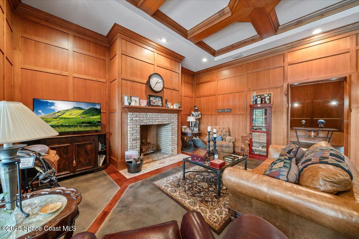 586 Wethersfield Place Melbourne, FL 32940 - Photo 59 of 112 a living room with furniture a fireplace and a flat screen tv
