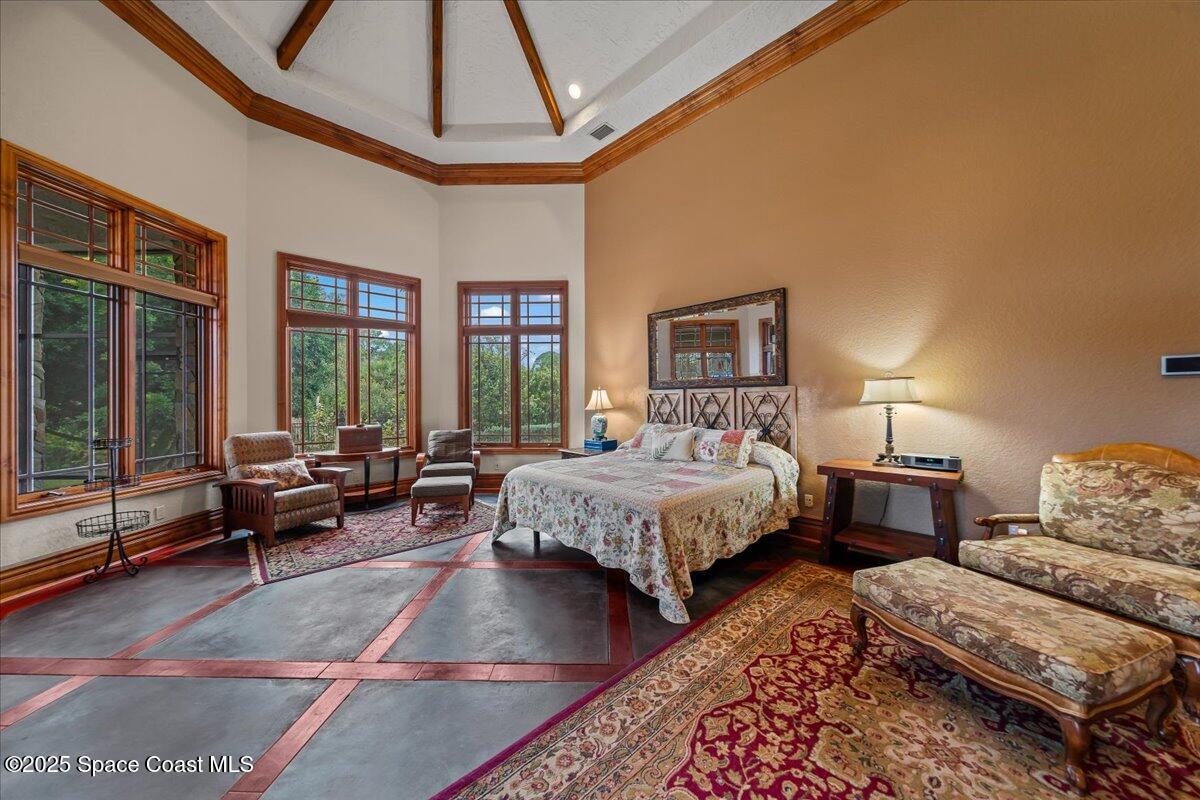 586 Wethersfield Place Melbourne, FL 32940 - Photo 63 of 112 a spacious bedroom with a bed a couch and large window