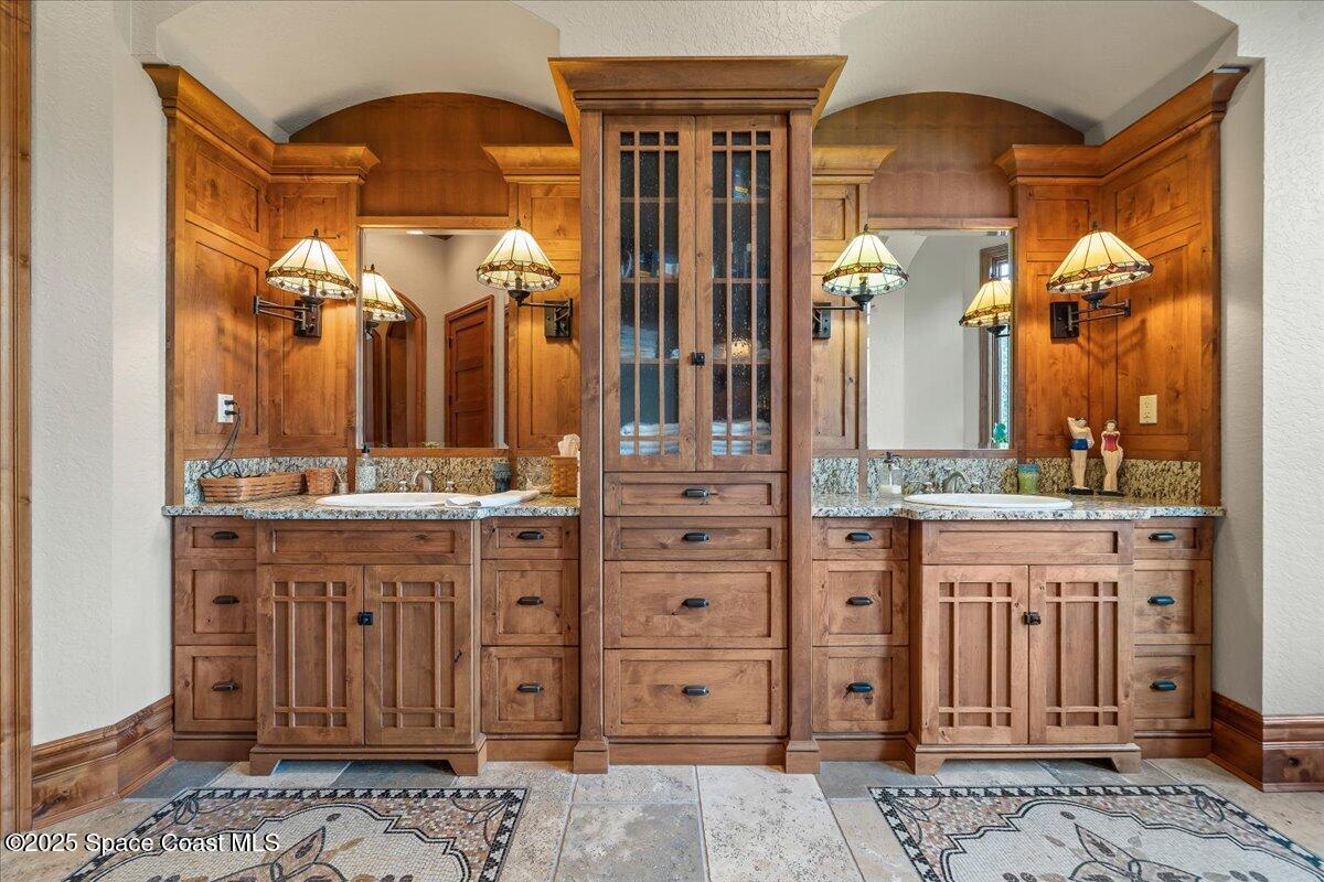 586 Wethersfield Place Melbourne, FL 32940 - Photo 65 of 112 a bathroom with a granite countertop sink vanity and a mirror