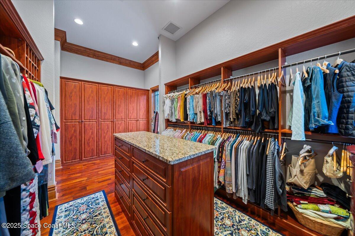 586 Wethersfield Place Melbourne, FL 32940 - Photo 70 of 112 a view of walk in closet with clothes and shoes