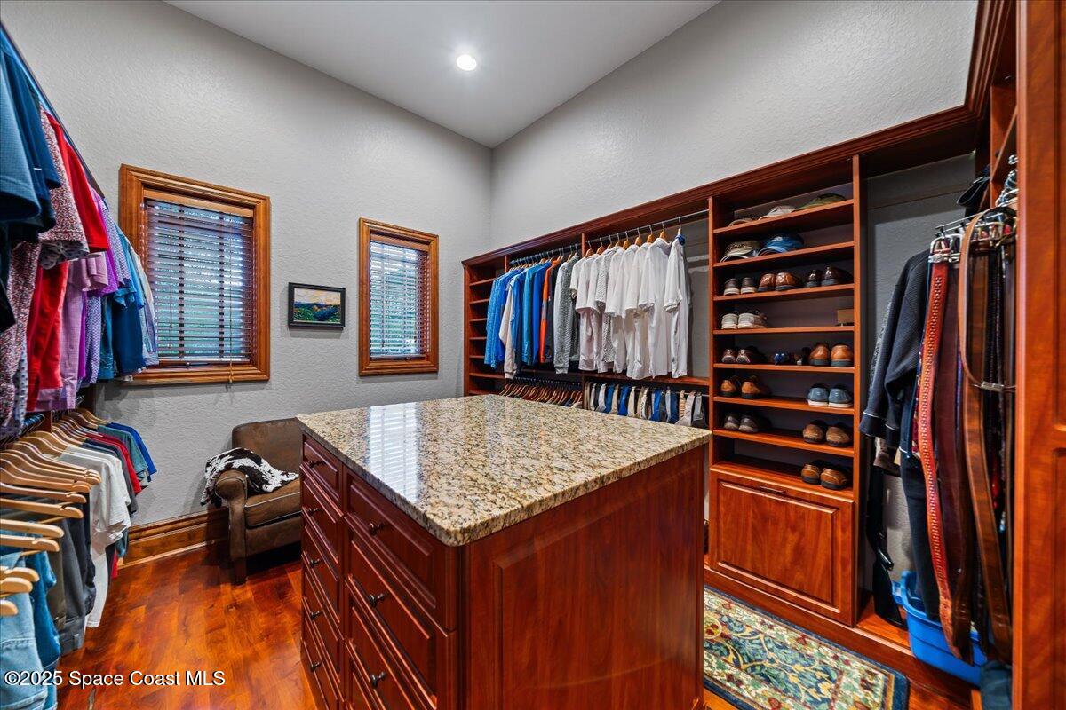 586 Wethersfield Place Melbourne, FL 32940 - Photo 72 of 112 a view of walk in closet with clothes and shoes