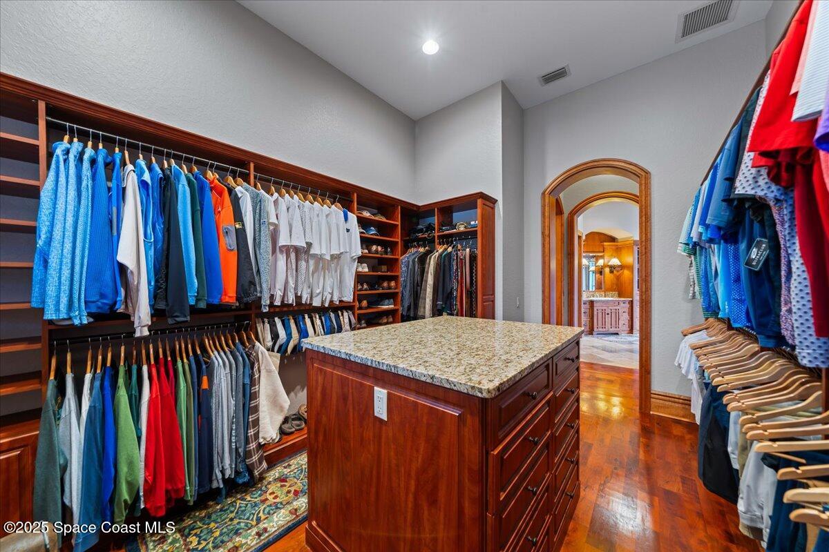 586 Wethersfield Place Melbourne, FL 32940 - Photo 73 of 112 a view of walk in closet with clothes and shoes