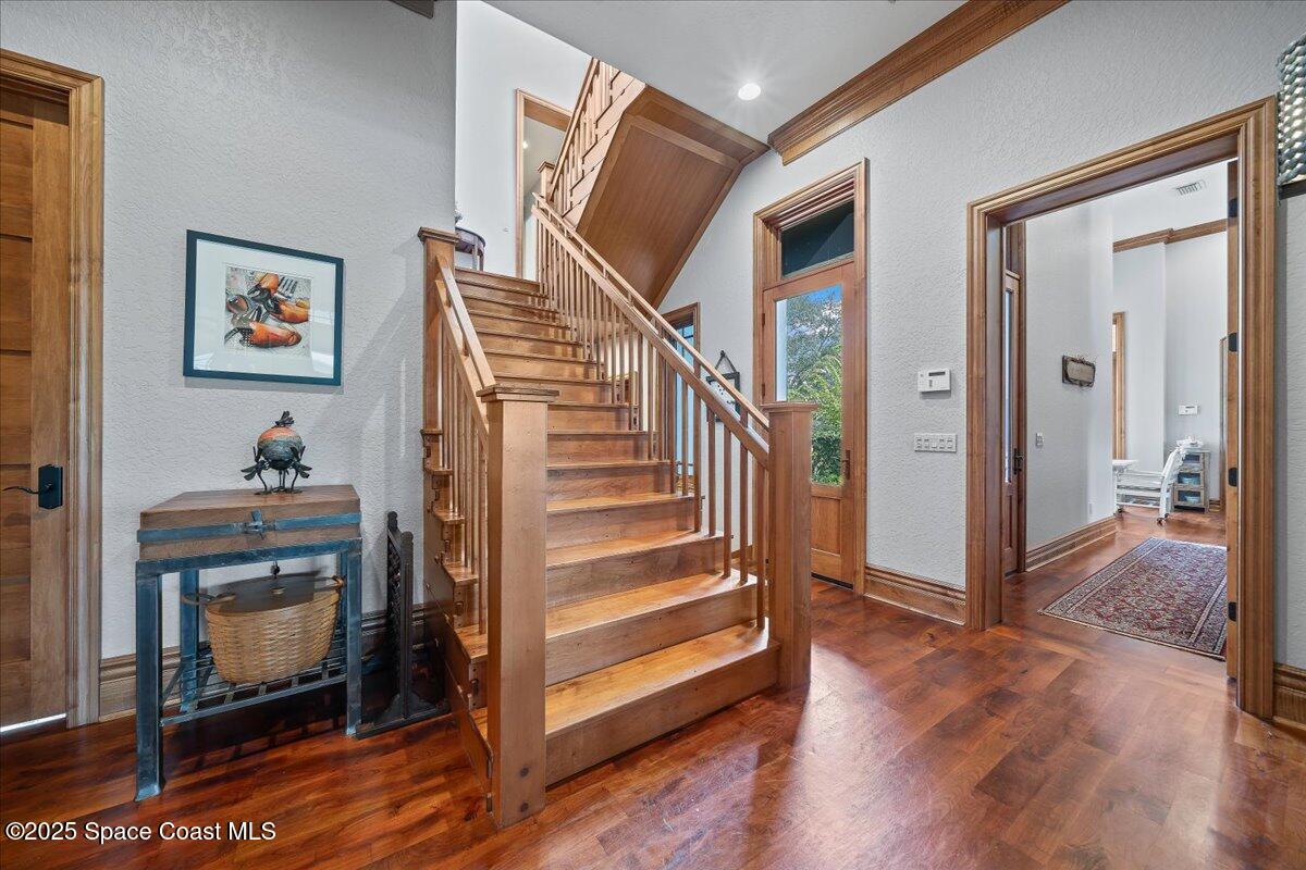 586 Wethersfield Place Melbourne, FL 32940 - Photo 92 of 112 a view of a hallway with wooden floor and staircase